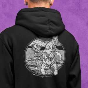 back closeup of person wearing black and white compassion co hoodie black with dog design against purple background