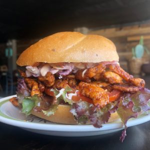 chicken sandwich with lettuce slaw and sauce