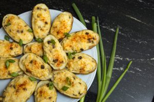 baked potatoes with chives on white plate