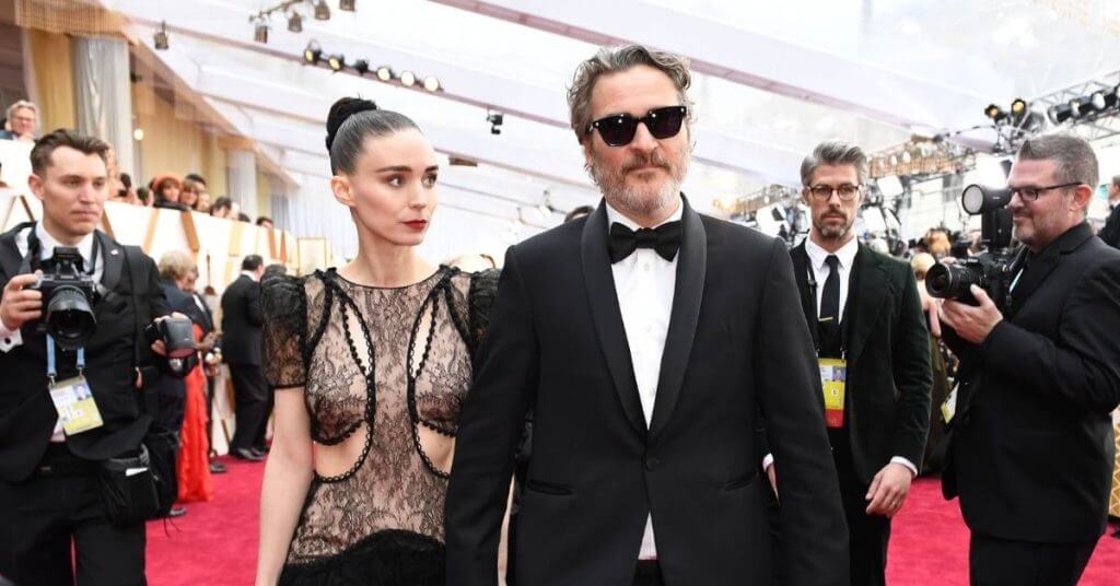 rooney mara and joaquin phoenix on red carpet surrounded by photographers