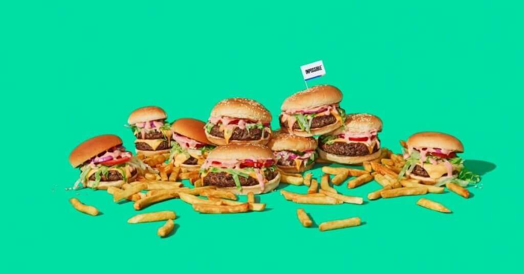 impossible burgers with fries with green background