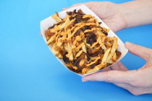 zonk burger slim fries drizzled with vegan cheese sauce