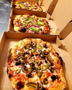 three plant fire pizzas with capsicum, mushroom and jalapeno toppings