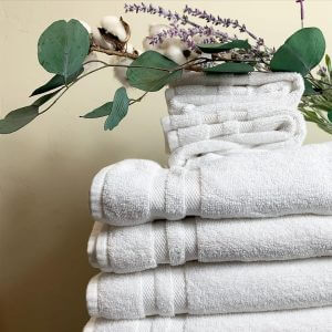 Fresh white towels topped with flowers