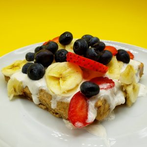 waffle with vanilla cream banana strawberries and blueberries