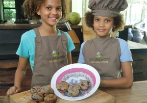 two girls model muffins chef hat and aprons tiny green chef kids cooking naturally